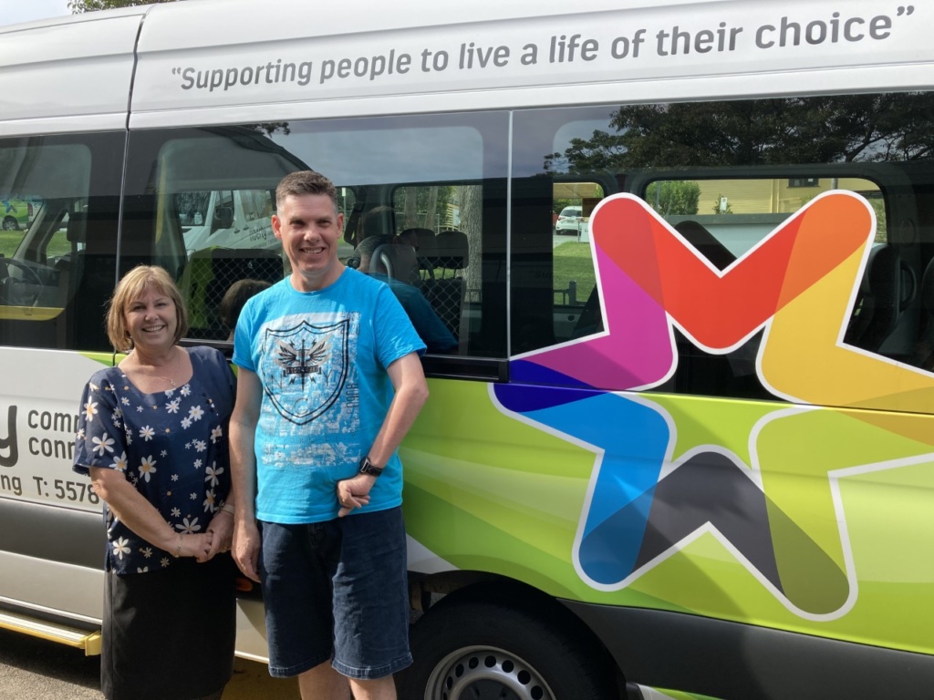 Rachelle and Daniel photo in front of liberty community bus talking about creating an independent life doing what you love