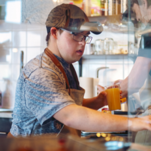 Hospitality industry disability employment person with downs syndrome working in Cafe