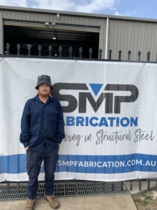 Mitch standing in front of SMP Fabrication - Hard Work does not frighten Mitch