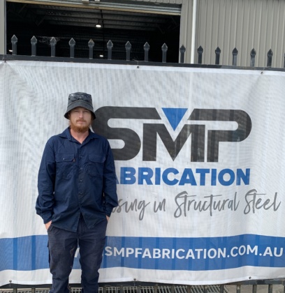 Mitch standing in front of SMP Fabrication - Hard Work does not frighten Mitch