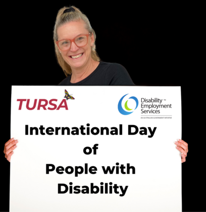 TURSA employee holding a sign that reads International Day of People with Disability IDPwD