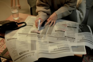 Person Searching For Job In The Newspaper