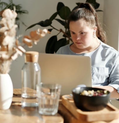 Young Girl Using Laptop Inside A Restaurant