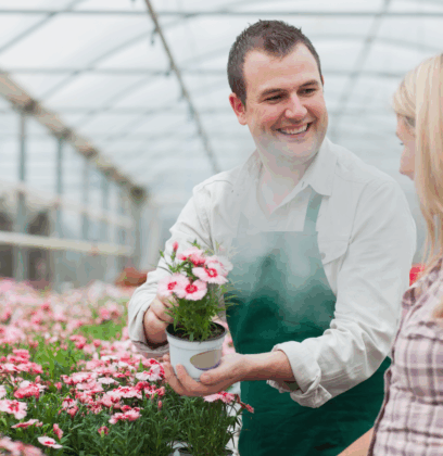 person holding flowers with a woman looking on to make a decision on which one