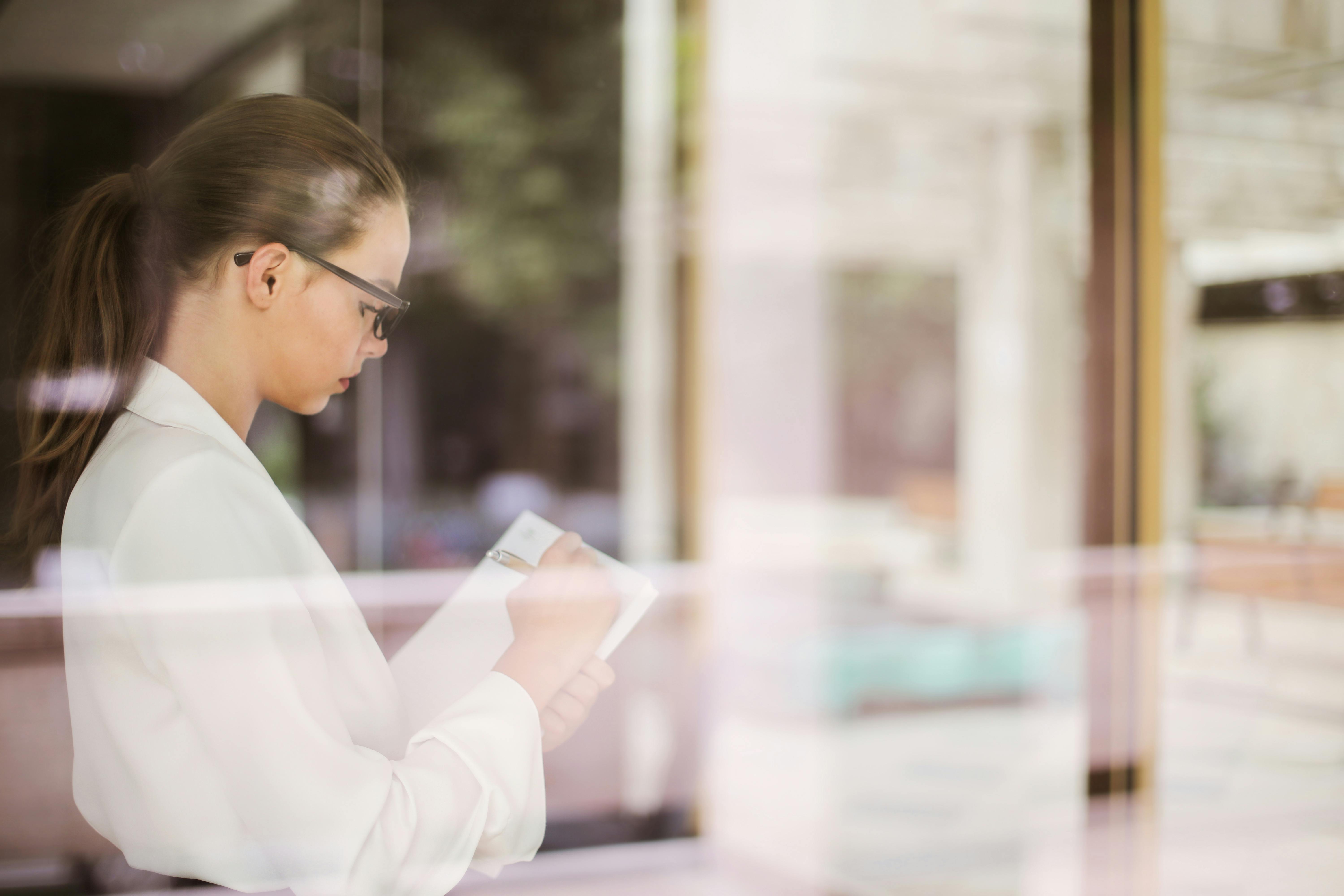 Female Taking Notes In Notebook