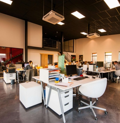 People Sitting On Chairs Behind Desks In An Office