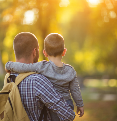 Article on Transferable Skill showing a parent holding child with sunlight glowing through the trees