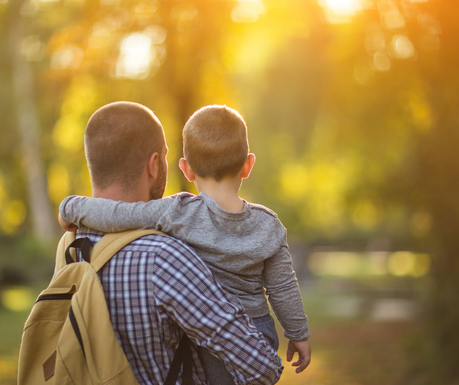 Article on Transferable Skill showing a parent holding child with sunlight glowing through the trees