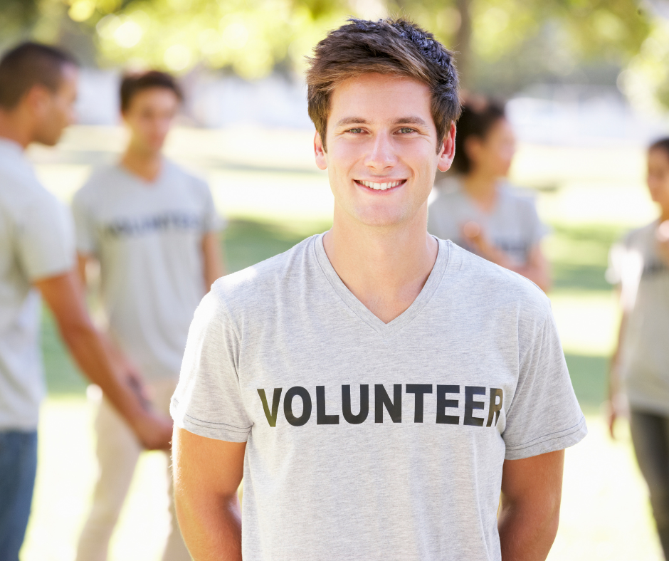 person smiling wearing a t-shirt that says volunteer for an article about Transferable skills